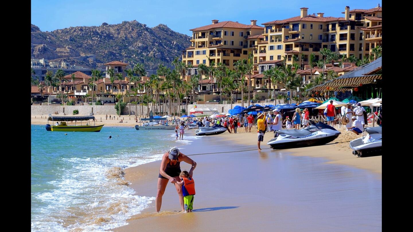 Helping a little one at Medano Beach in Cabo San Lucas.