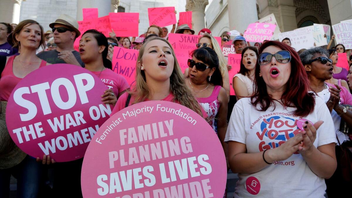 Planned Parenthood supporters rally for women's access to reproductive health care on "National Pink Out Day'' at Los Angeles City Hall in 2015.