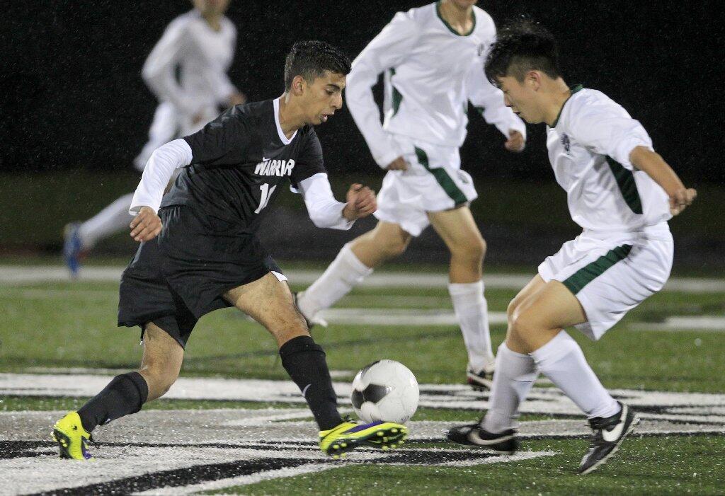 Brethren Christian's Ebram Gerges, left, dribbles the ball against Sage Hill's Danny Lee, right, during the second half against in an Academy League game on Thursday.