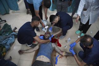 Palestinian medics treat a wounded man in the Israeli bombardment of the Gaza Strip at Al Aqsa hospital in Deir al Balah, Gaza Strip, on Saturday, May 11, 2024. (AP Photo/Saher Alghorra)