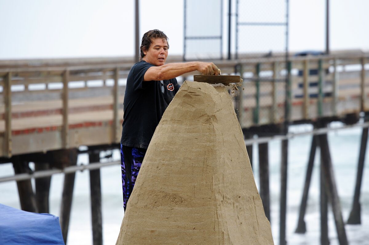 IB Posse member Mark Durazo works on a structure at Sun and Sea Festival on Saturday, July 13, 2019.