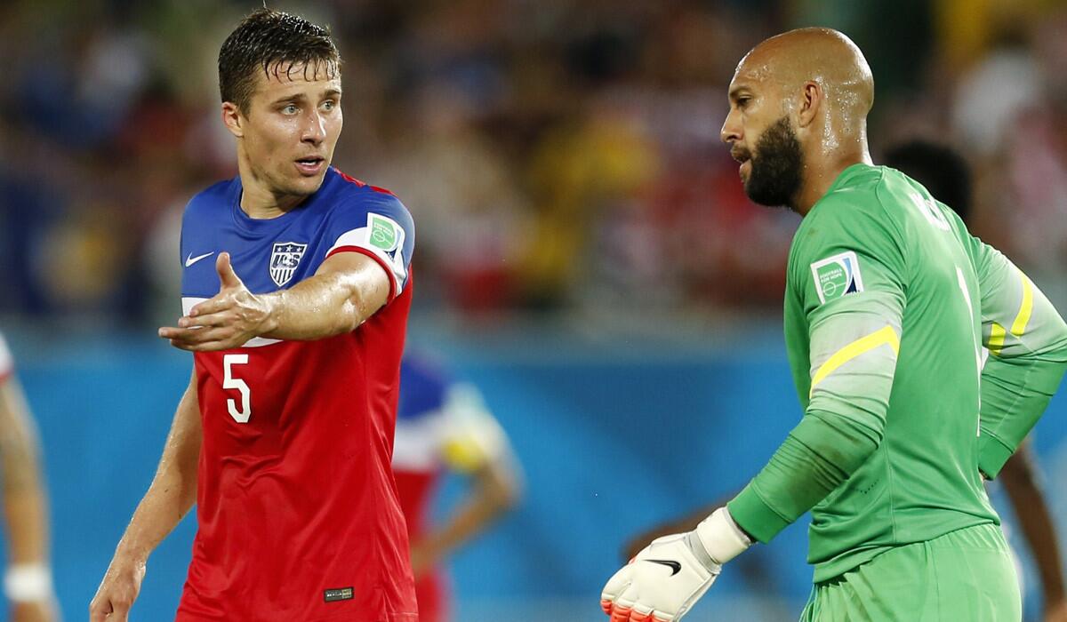 U.S. defender Matt Besler (5) talks to goalkeeper Tim Howard as they walk off the pitch during halftime of their eventual 2-1 victory over Ghana on Monday.