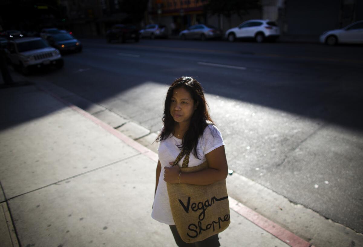 Seamstress Yeni Dewi is one of many Los Angeles garment workers who are required to cash their paychecks at check cashing companies.