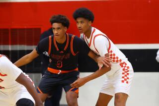 It was the battle of sons from NBA dads. Tajh Ariza of Westchester (right) covers Chatsworth's Alijah Arenas.