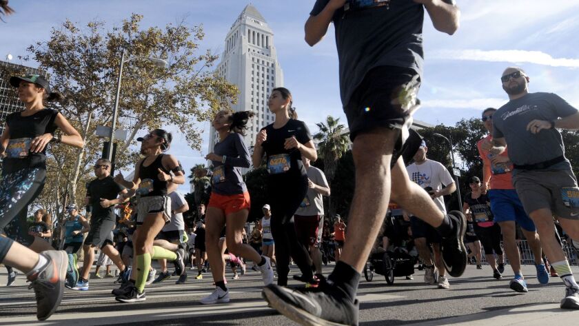 Thousands turned out for the fifth annual Turkey Trot Los Angeles near City Hall as temperatures broke records in the region.