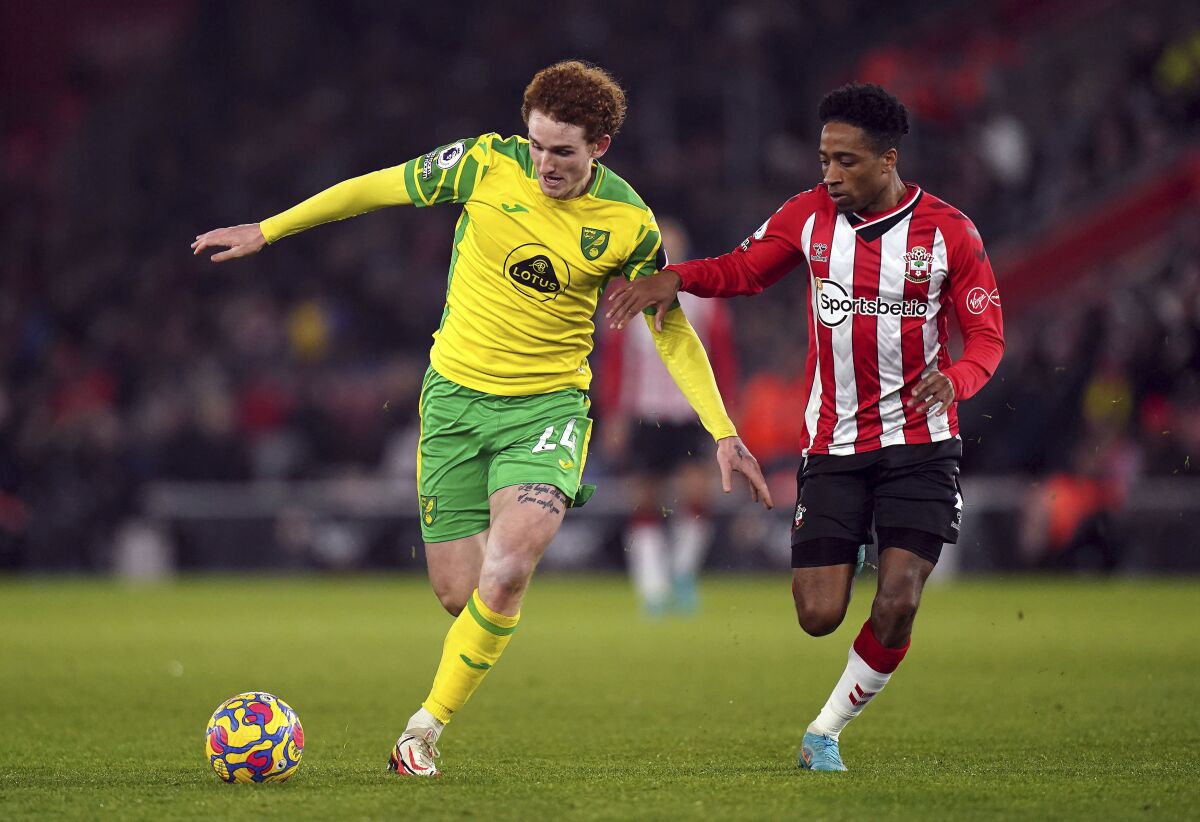 Norwich City's Josh Sargent, left, and Southampton's Kyle Walker-Peters battle for the ball during the English Premier League soccer match at St. Mary's Stadium, in Southampton, England, Friday, Feb. 25, 2022. (Adam Davy/PA via AP)