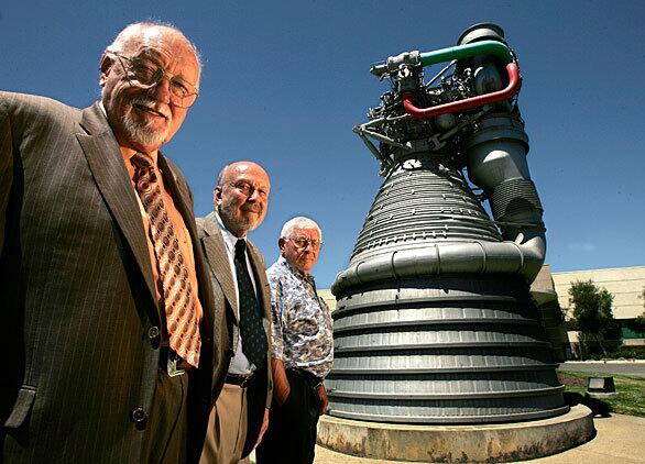 Rocket scientists Bob Biggs, 75, left, Paul Coffman, 74, and Joe Stangeland, 73, with a giant F-1 rocket engine on display in front of the Canoga Park headquarters of Rocketdyne, where the men worked. This is the same kind of rocket engine that was used in the Saturn V rocket that carried Neil Armstrong and Buzz Aldrin to the moon.