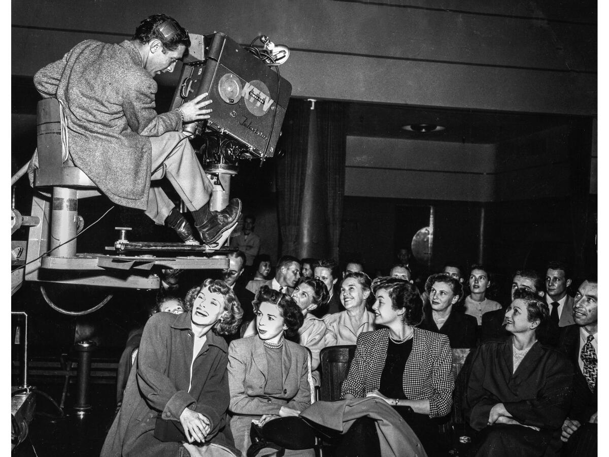 Nov. 7, 1950: KTTV cameraman swings over audience in the Los Angeles Times auditorium during live coverage of the general election. Sitting front row from left are Shirley Britt, Noreen Enright and Carolyn Ames. The fourth woman was not identified.