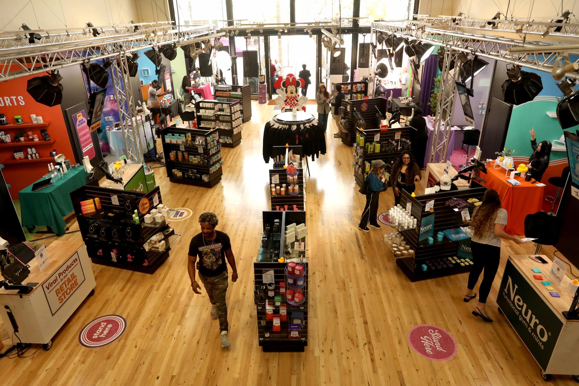 An airy, wood-floored retail space with various booths housing different vendors