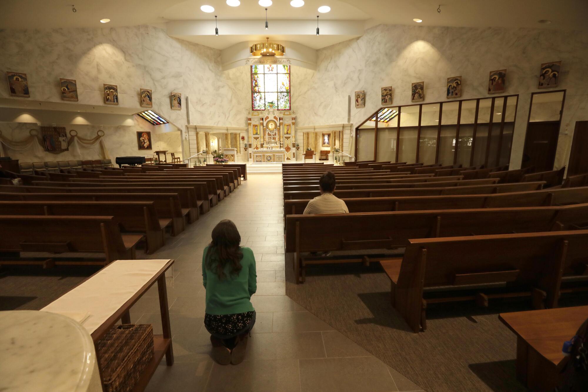 Marriage & Family therapist Elena Zuniga prays on her knees after a monthly meeting of Dymphna's Disciples in Yorba Linda.