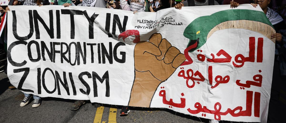 A sign at a demonstration supporting Palestinians at Pershing Square in Los Angeles on Saturday.
