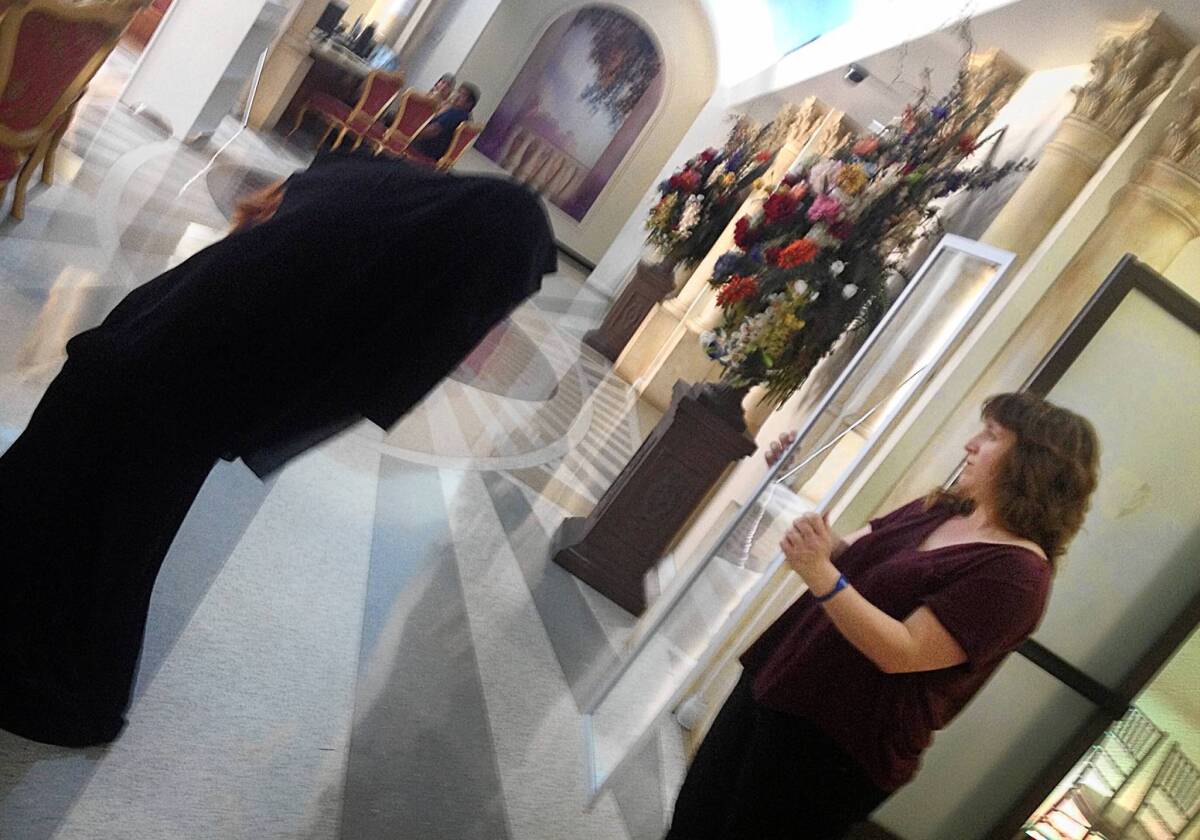 Artist Marie Rim, right, with Monica Parra, who is trying on a burka for Rim's art project.