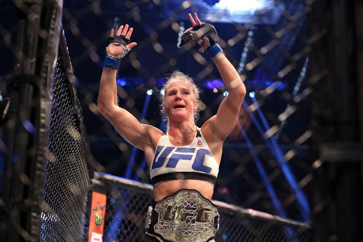 Holly Holm wears the women's bantamweight belt she won from Ronda Rousey during UFC 193 in Melbourne, Australia.