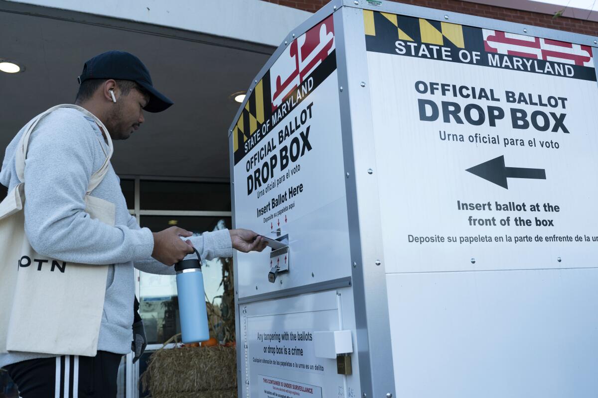 A voter places his ballot in a drop box in Burtonsville, Md., on Nov. 8, 2022. 