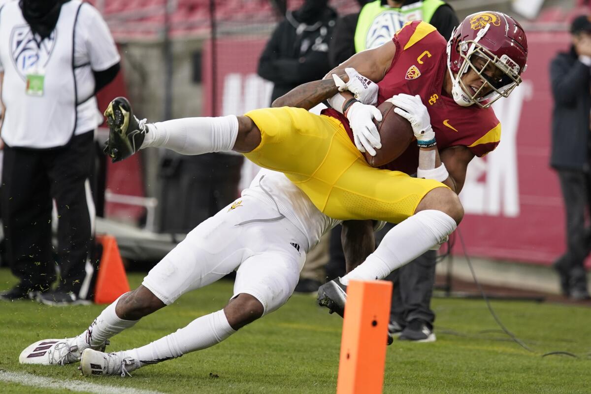 USC wide receiver Amon-ra St. Brown is tackled by Arizona State defensive back Jack Jones on Nov. 7, 2020.