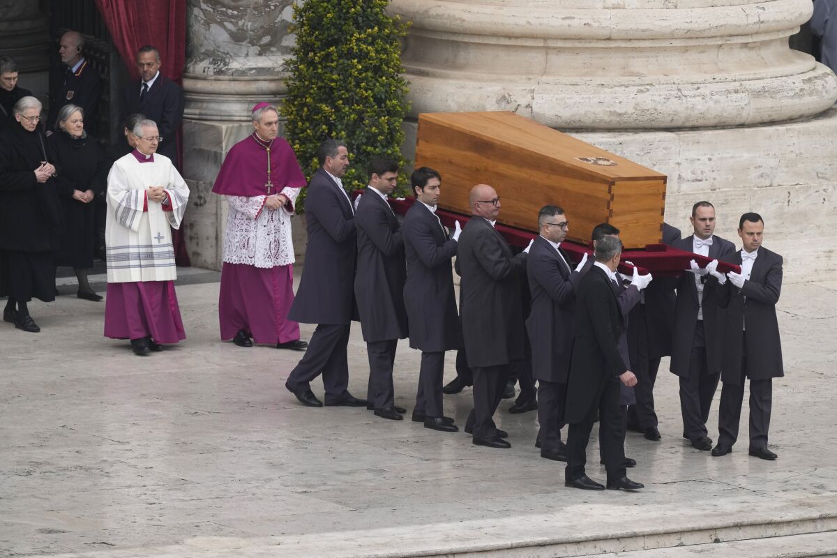 Coffin of Pope Emeritus Benedict XVI borne by pallbearers