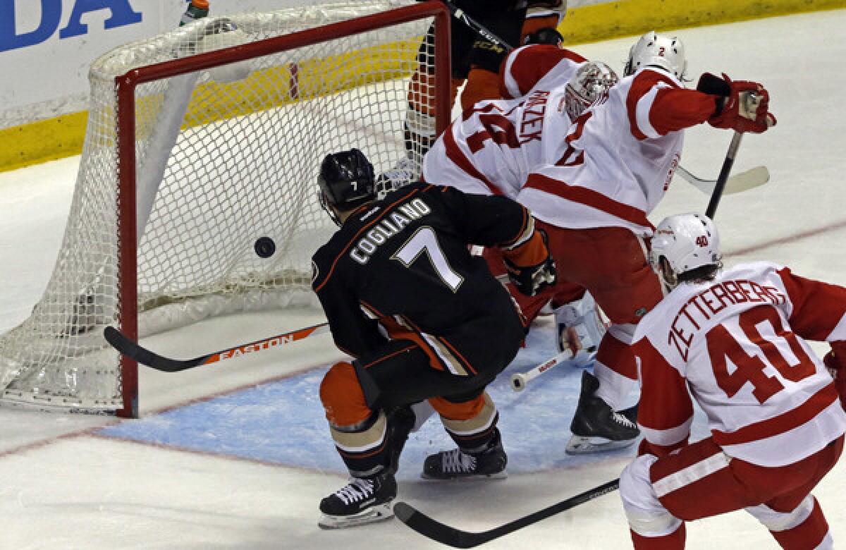 Ducks center Andrew Cogliano, left, scores past Detroit Red Wings goalie Petr Mrazek during the second period of the Ducks' 1-0 win Sunday.