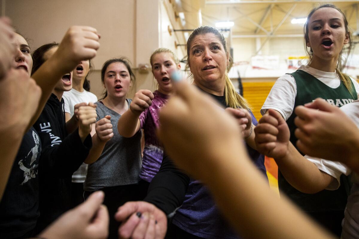 Coach Sheila Craft and the Paradise High School Bobcats cheer together at the end of practice at the Chico High School gym on Thursday.