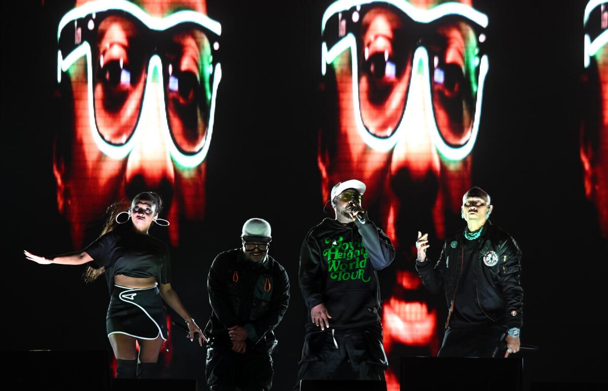 The Black Eyed Peas perform at halftime of the East L.A. Classic at the Coliseum on Friday night.