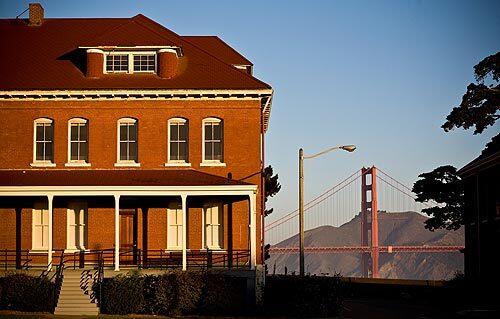 The Golden Gate Bridge is seen behind the Montgomery Street barracks at the Presidio, one of San Francisco's most beloved public spaces.