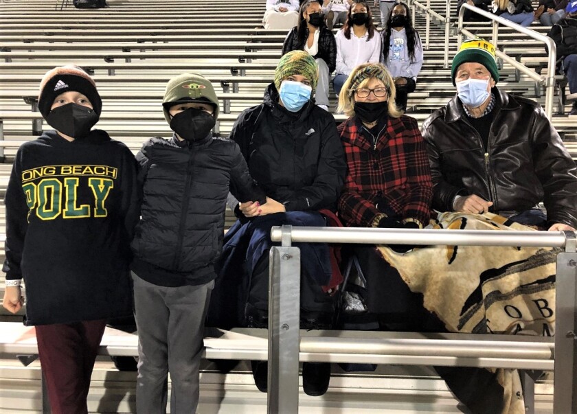 The family of Long Beach Poly football coach Stephen Barbee watches the game Friday against Serra at Jaguar Stadium.