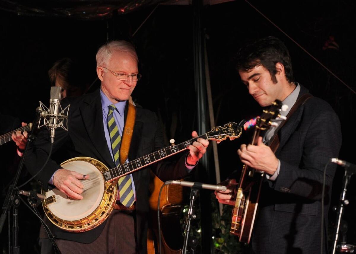 Steve Martin, left, and Noam Pikelny of the Punch Brothers duel with banjos during a special show featuring music from the Coen brothers' upcoming movie "Inside Llewyn Davis."