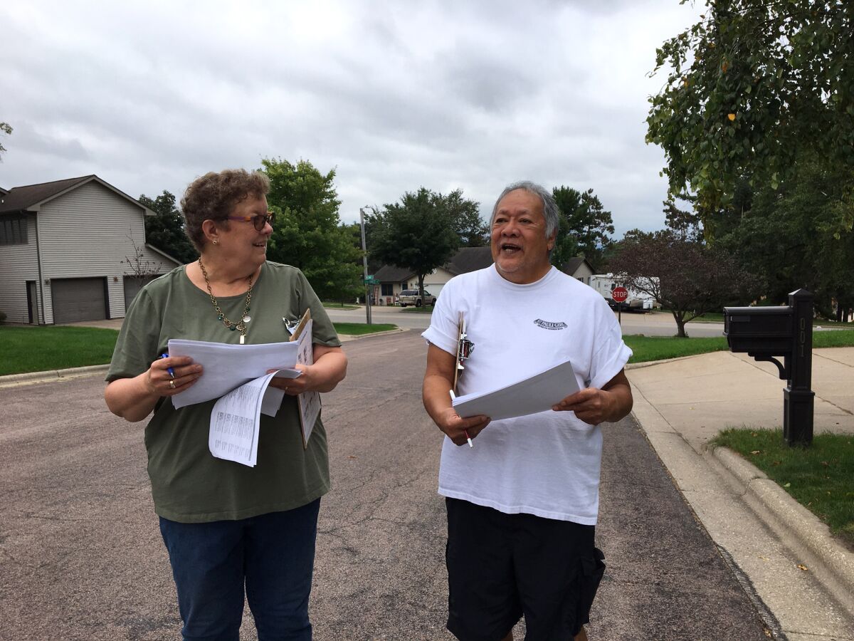 Democrats Carol Klitzke and Marlo Santillan canvass a neighborhood in Onalaska, Wis.