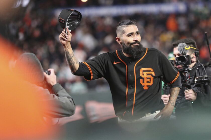 San Francisco Giants' Sergio Romo tips his cap after the final relief appearance of his career during Bay Bridge Series against Oakland Athletics at Oracle Park in San Francisco, Monday, March 27, 2023. (Scott Strazzante/San Francisco Chronicle via AP)