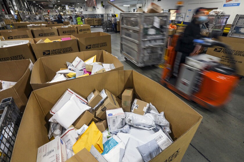 A mail and packages in containers at a USPS processing and distribution center in City of Industry. 