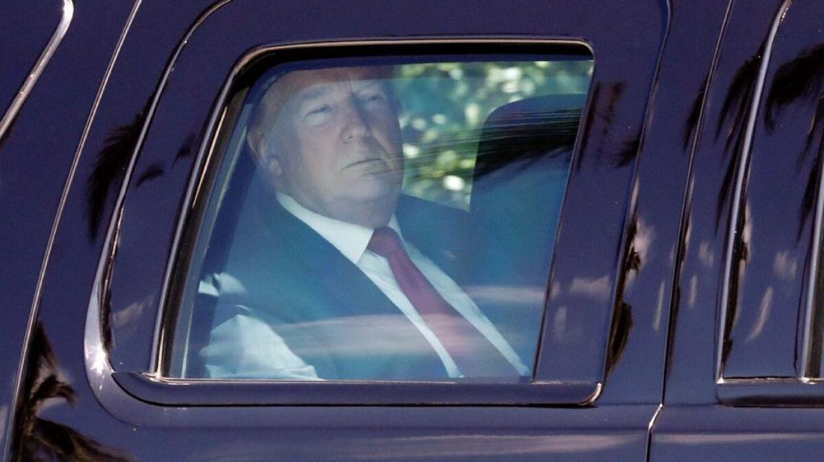 President Trump inside his armored SUV as he departs his Mar-a-Lago estate to attend Easter services at nearby Episcopal Church of Bethesda-by-the-Sea on Sunday in Palm Beach, Fla.