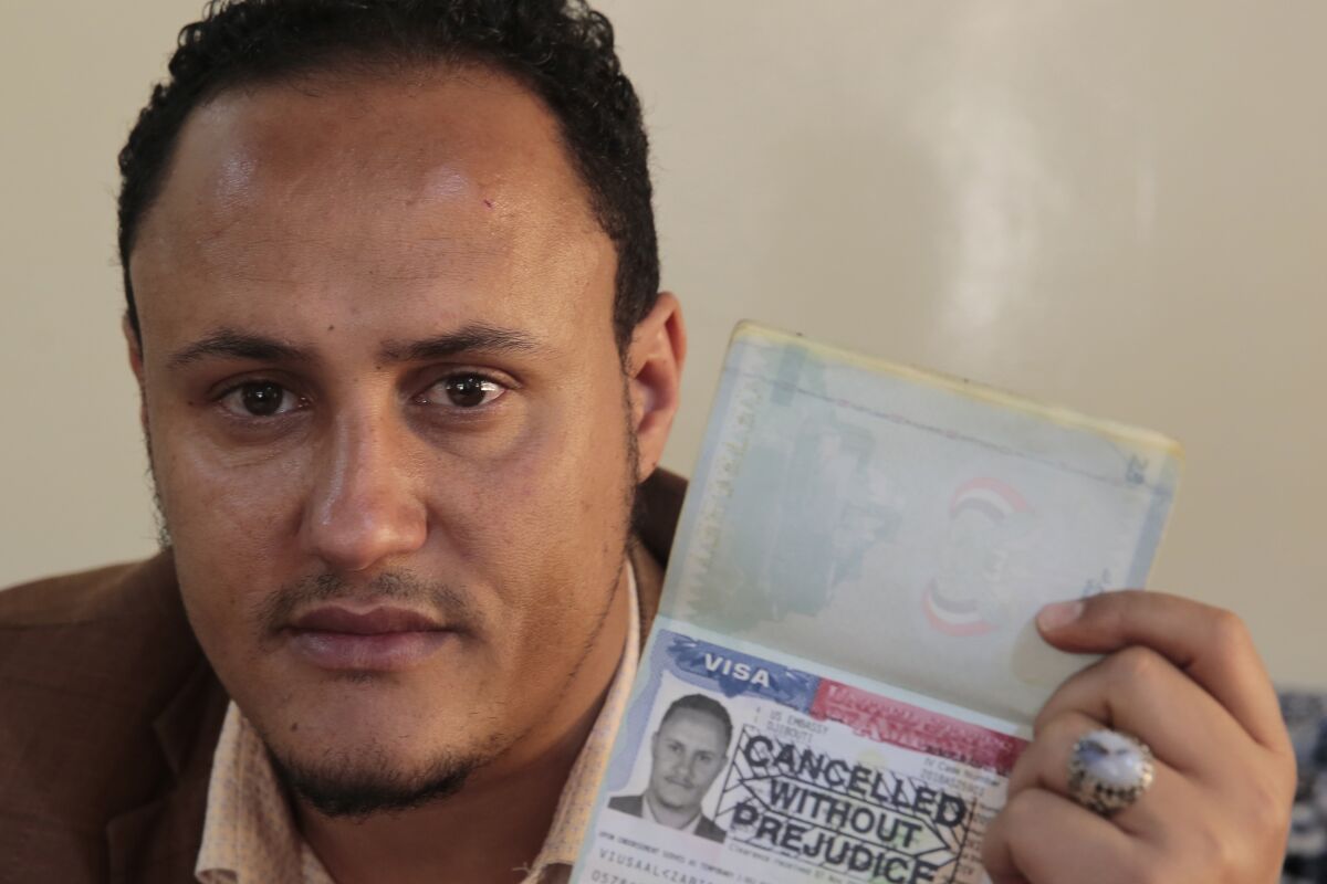 Mohammed Al Zabidi holds his canceled U.S. visa