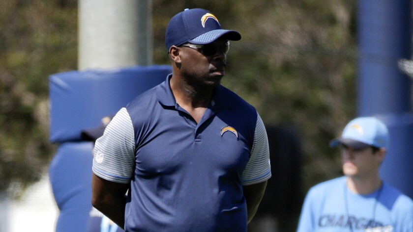 Coach Anthony Lynn watches the Chargers go through their first workout of training camp Sunday in Costa Mesa.