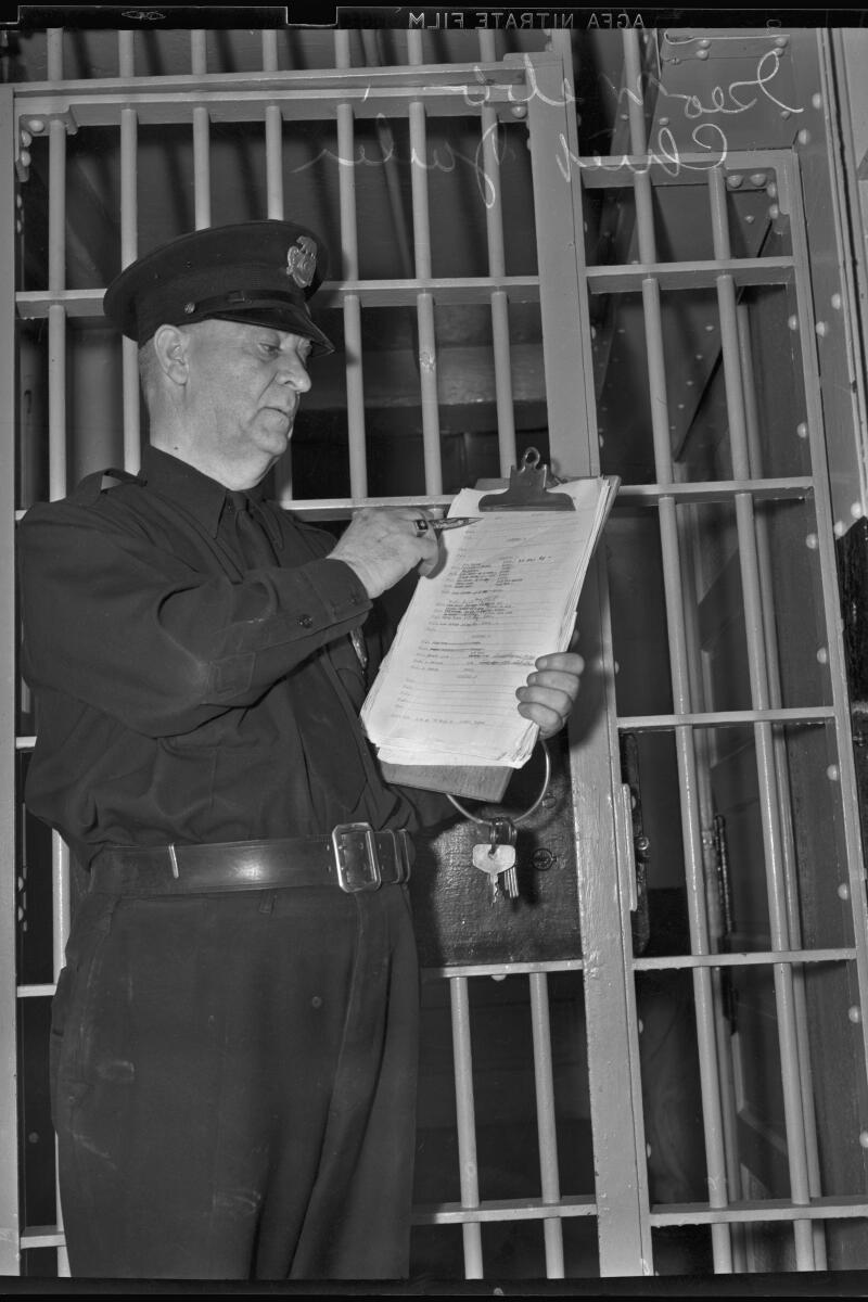 Chief jailer George Webb checks a list of articles to be moved to temporary quarters on the city pier in Dec. 7, 1938.