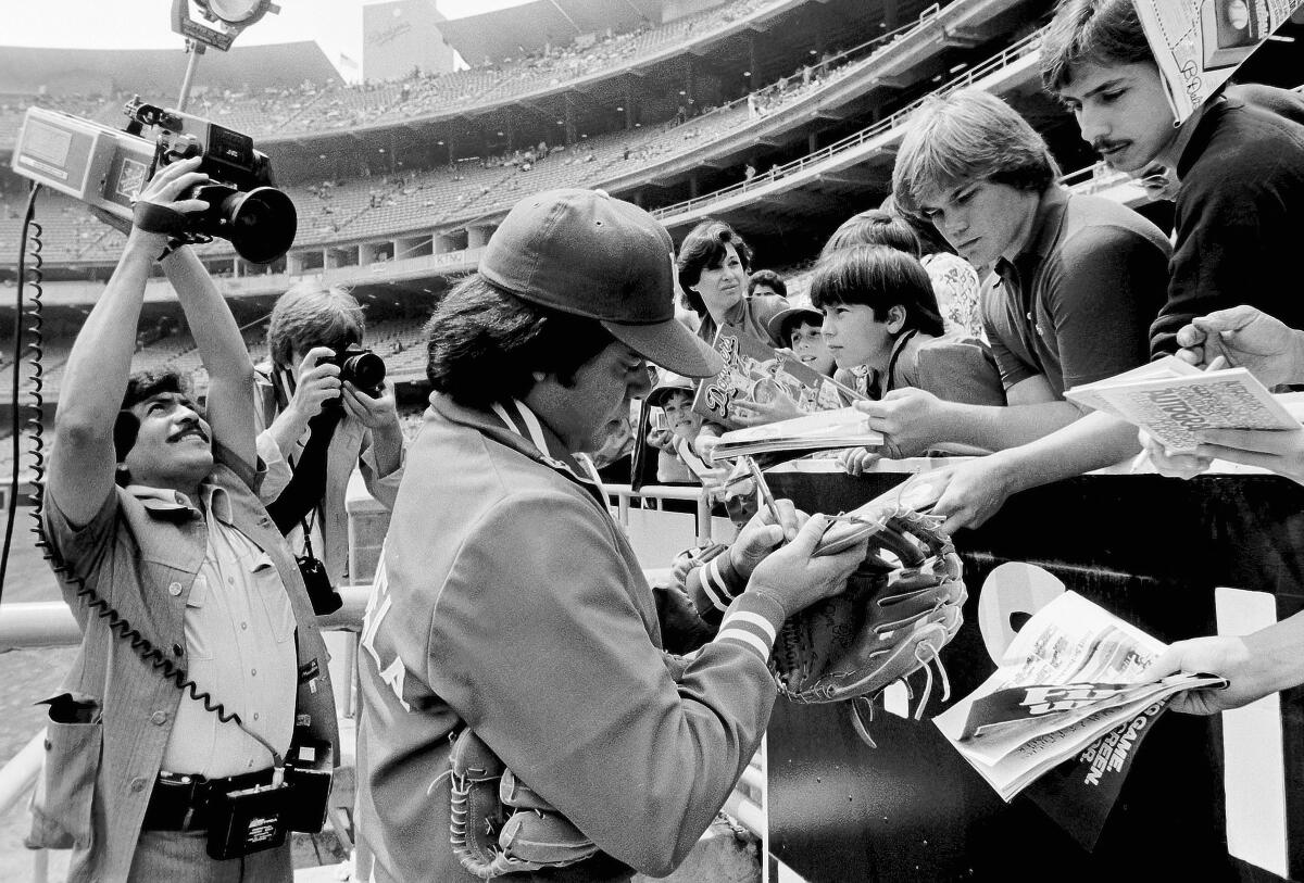 Fernando Valenzuela signs autographs at Dodger Stadium.