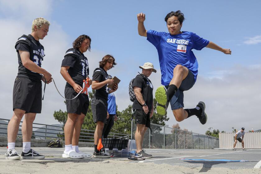 SANTEE, CA-MAY 20: Alex Rowley,14, from the Calsbad Colts long jumps during the Special Olympics Southern California at West Hills High School in Santee.(Photo by Sandy Huffaker for The SDUT)