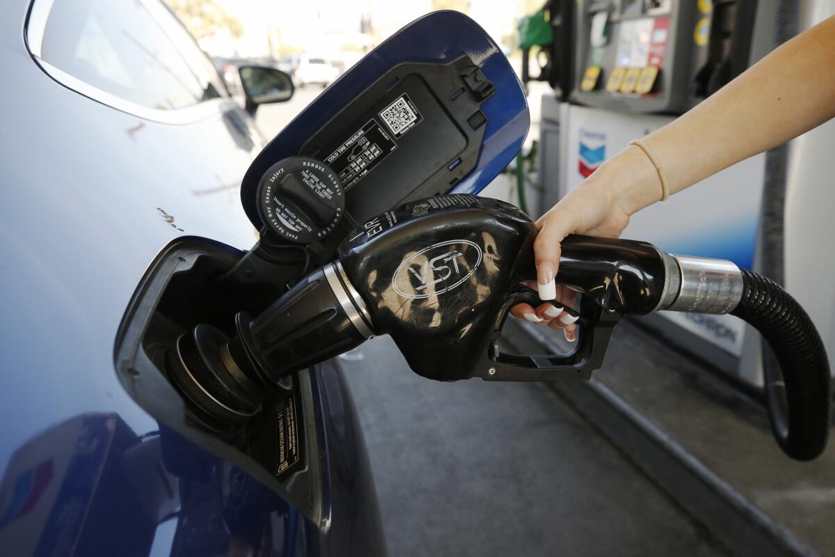 Montana Tomkyns puts gas in her tank at a Chevron station near Union Station in downtown Los Angeles. 