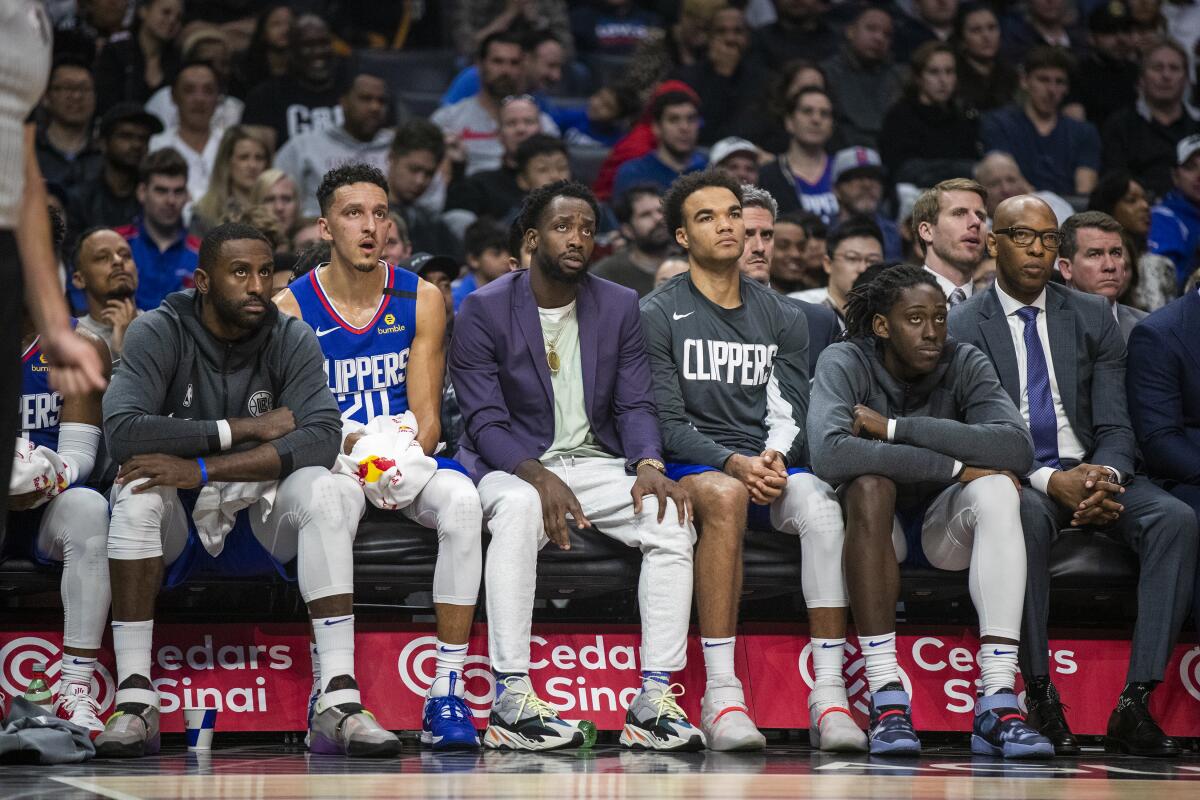 Players on the Clippers' bench react during the final minutes of the team's 140-114 loss to the Grizzlies on Saturday afternoon.