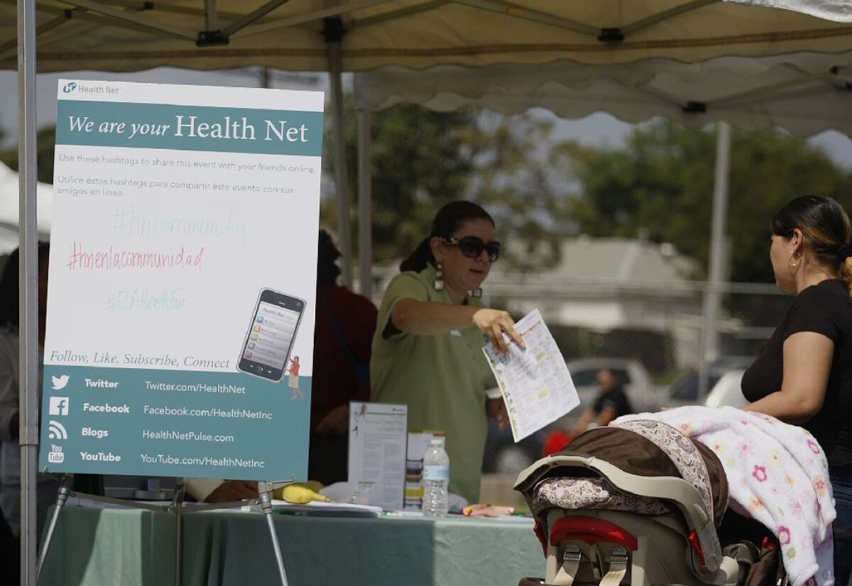 Insurers tell consumers about their new options in the state's health insurance exchange at a recent health fair in East Los Angeles.