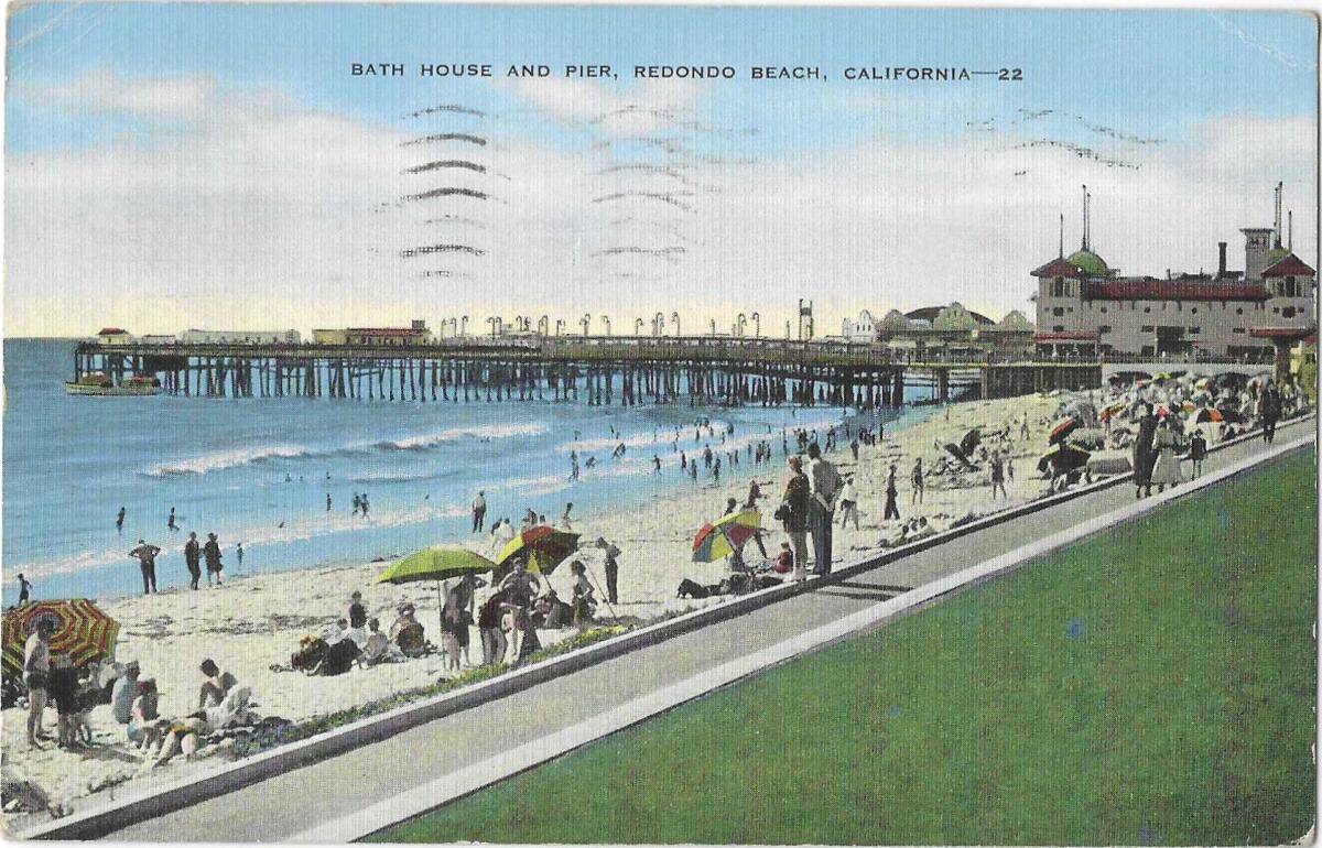 People lie on the strip of sand south of the Redondo Beach Pier