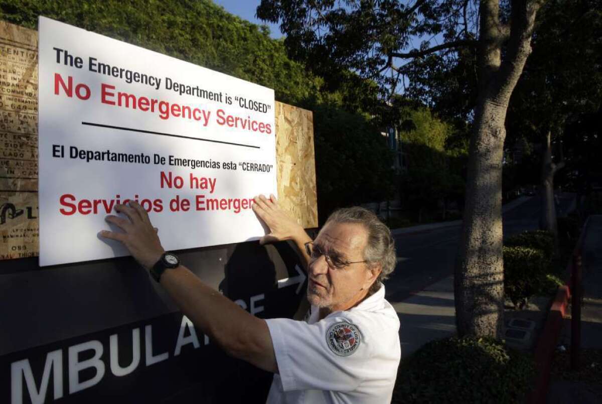A worker posts a sign at the entrance of Martin Luther King Jr.-Harbor Hospital's emergency room in Los Angeles in 2007, after it was announced that the emergency room would close. A new study finds that patients from neighborhoods affected by ER closures are more likely to die if they are admitted to a hospital.