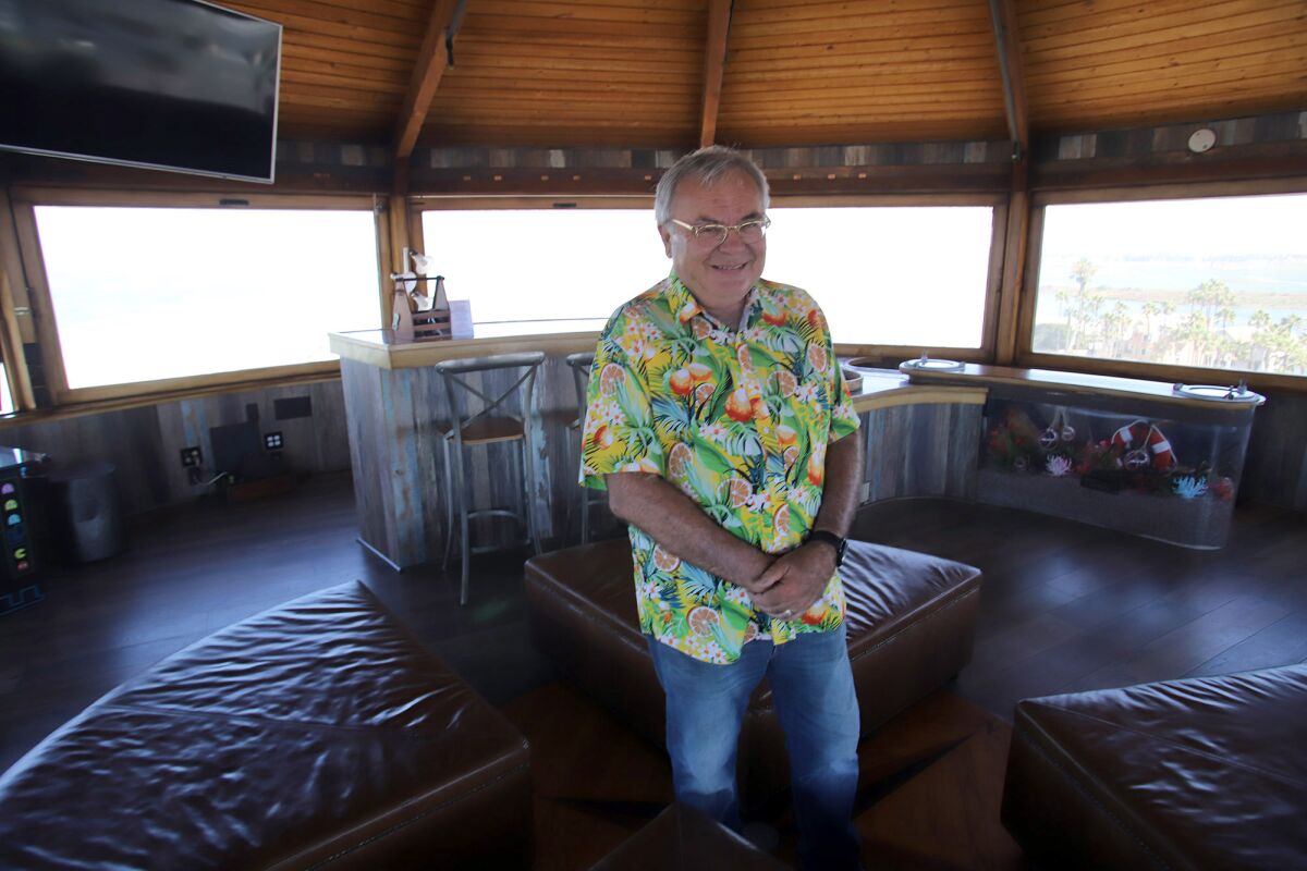 Dr. Gregg DeNicola stands in the top lounge room of the Water Tower House. 