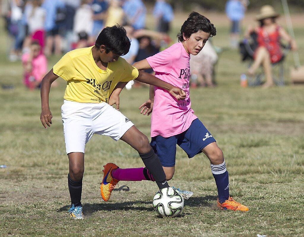 Carden Hall's Sachin Wijay, left, and St. Joachim's Max Macias battle for ball control at midfield.