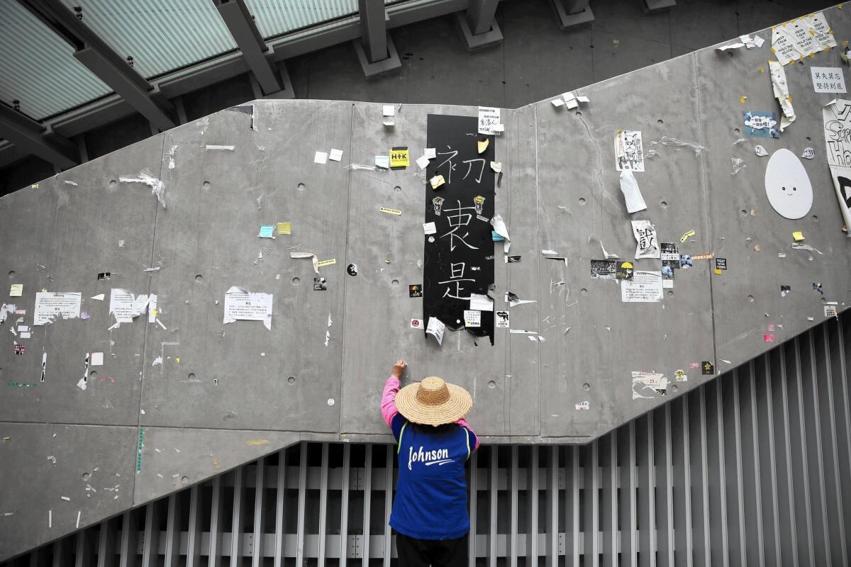 A worker cleans up an area of the main pro-democracy protest site in the Admiralty district of Hong Kong on Dec. 12.