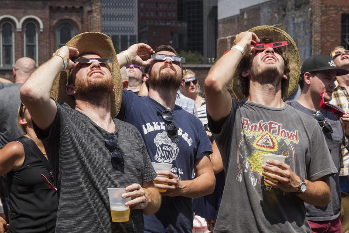 Revelers observe the solar eclipse from the rooftop bar of Nudie's Honkey Tonk in Nashville.