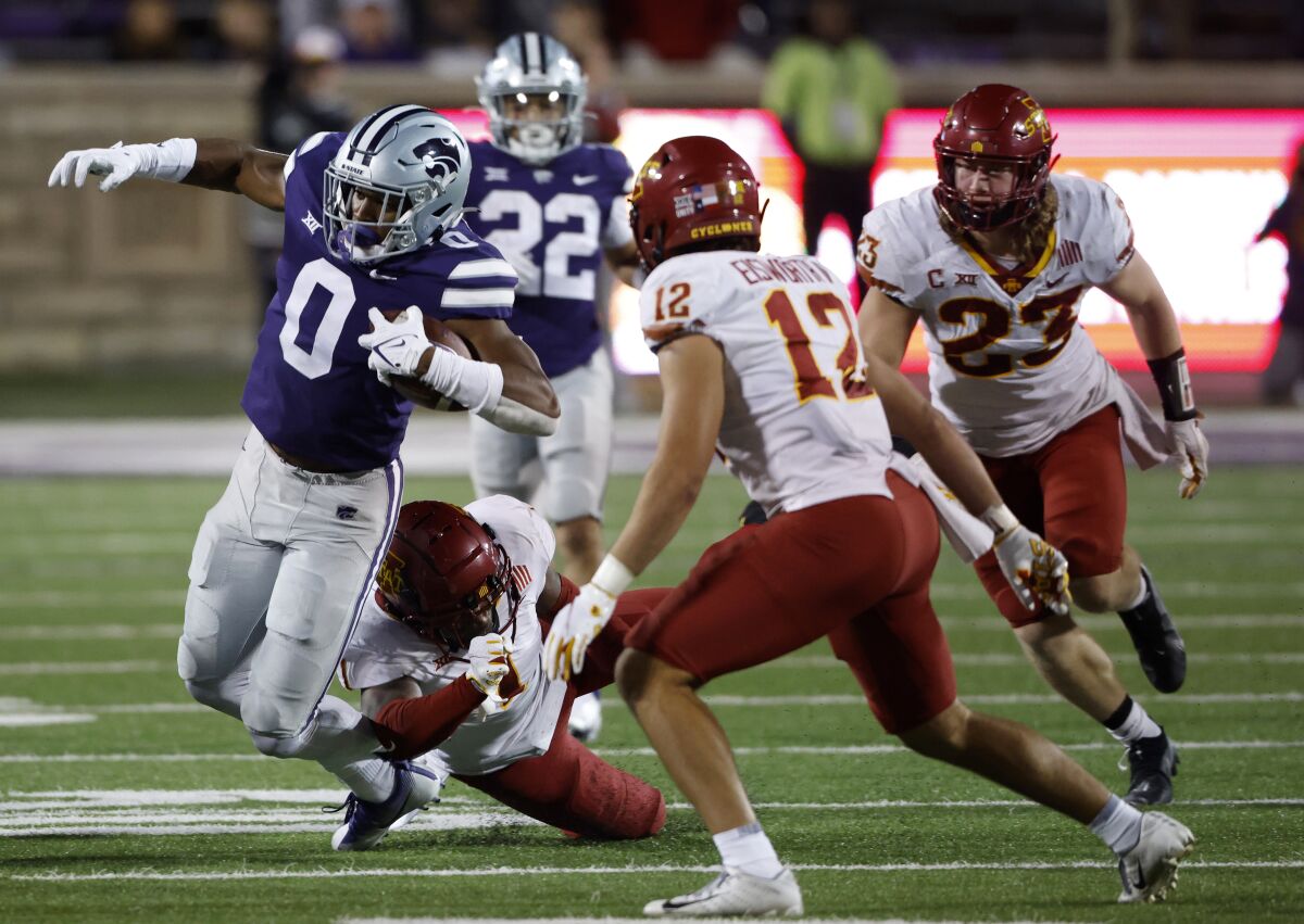 Kansas State tight end Daniel Imatorbhebhe (0) is tackled by Iowa State defensive back Isheem Young (1) as defensive back Greg Eisworth II (12) and linebacker Mike Rose (23) also defend during the fourth quarter of an NCAA college football game Saturday, Oct. 16, 2021, in Manhattan, Kan. (AP Photo/Colin E. Braley)