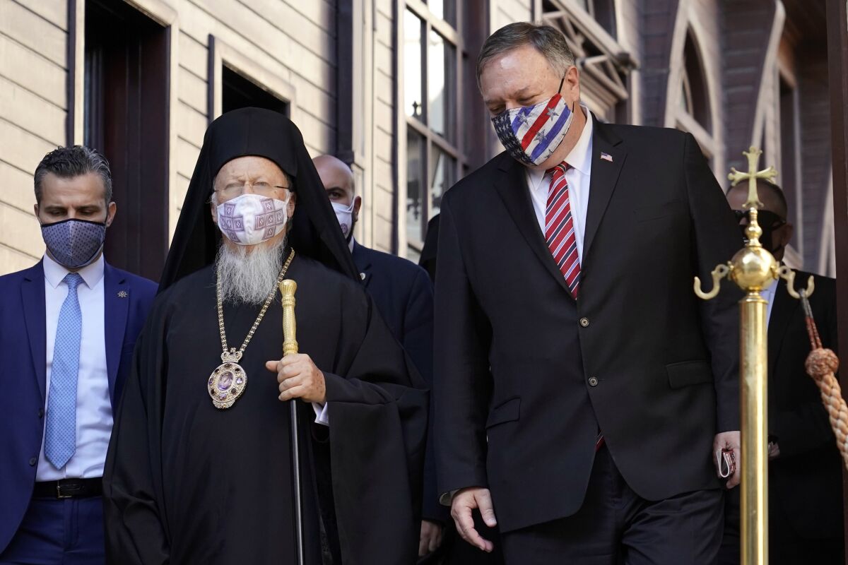 Secretary of State Mike Pompeo, right, speaks with Ecumenical Patriarch Bartholomew I, the spiritual leader of the world's Orthodox Christians, before departing the Patriarchal Church of St. George in Istanbul, Tuesday, Nov. 17, 2020. Pompeo's stop in Turkey is focused on promoting religious freedom and fighting religious persecution, which is a key priority for the U.S. administration, officials said. (AP Photo/Patrick Semansky, Pool)