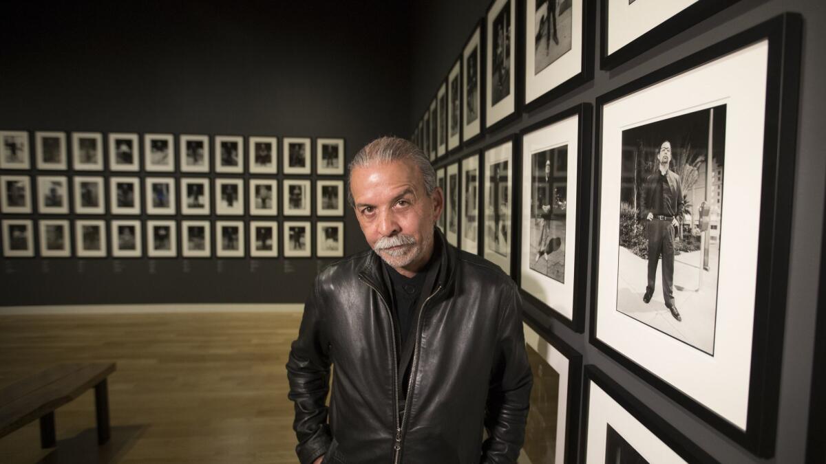 Artist Harry Gamboa Jr. stands amid his installation "Chicano Male Unbonded" at the Autry Museum.