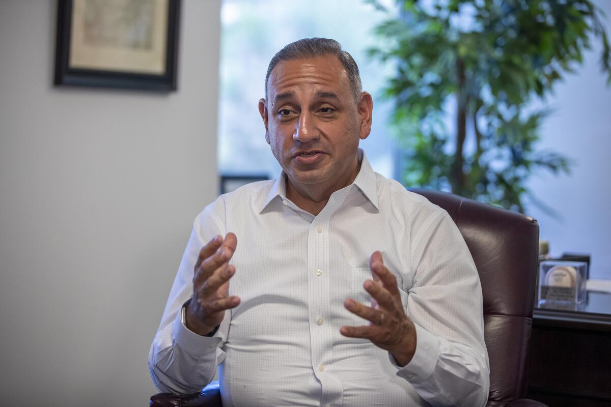Rep. Gil Cisneros of Yorba Linda talks to constituents at his office in Fullerton in July 2019. The freshman Democrat was one of seven lawmakers whose call for an impeachment investigation swayed others in the House.
