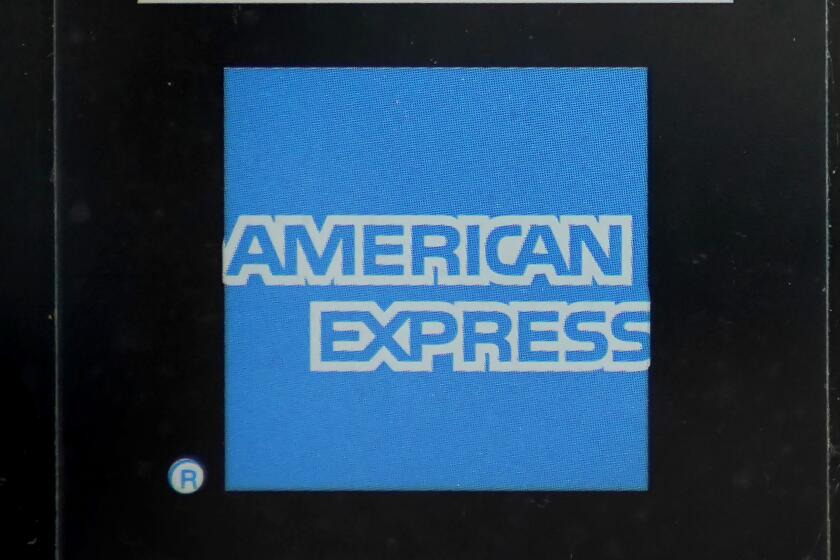 FILE - An American Express logo is attached to a door in Boston's Seaport District, Wednesday, July 21, 2021. American Express reports their earnings (AP Photo/Steven Senne, File)