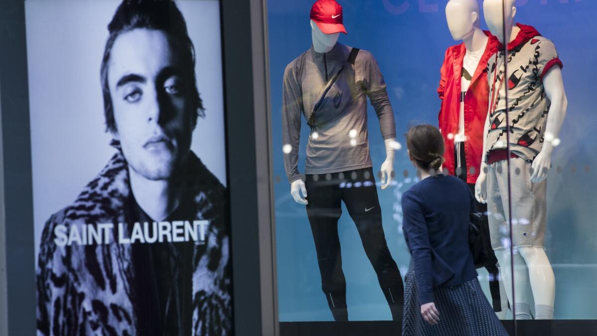 An advertisement for Saint Laurent is seen on a bus stop at the Lord & Taylor flagship store on Fifth Avenue in New York this month.